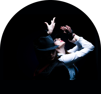 sample-img A man in white shirt and hat dancing on black background.