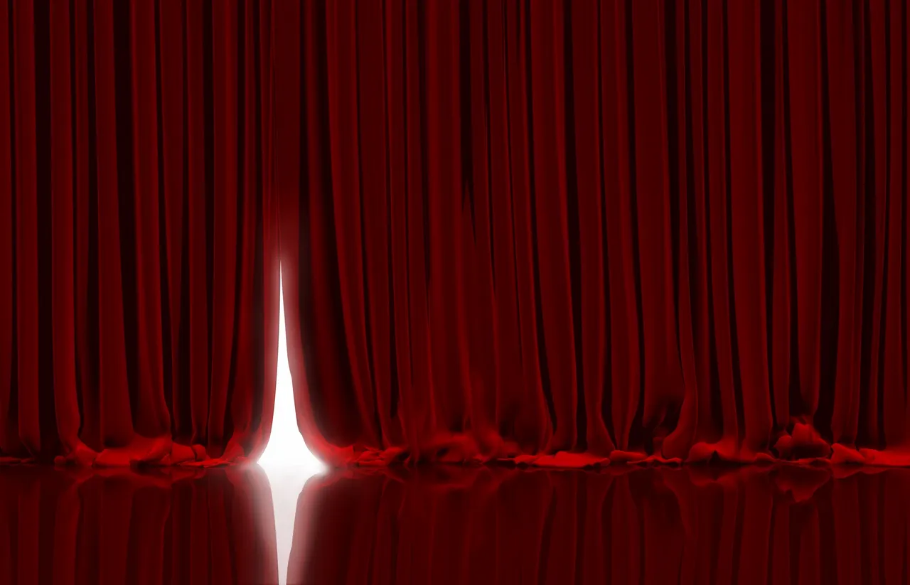 rs=w_1280 (1) A red curtain with a white light shining through it.