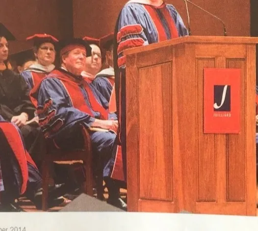 rs=w_1280 (5) A man in blue and red robes is speaking at a podium.