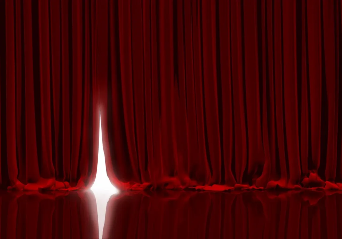 rs=w_1280 (1) A red curtain with a white light shining through it.