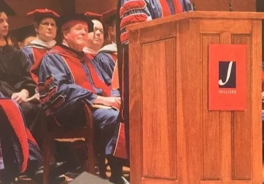 rs=w_1280 (5) A man in blue and red robes is speaking at a podium.